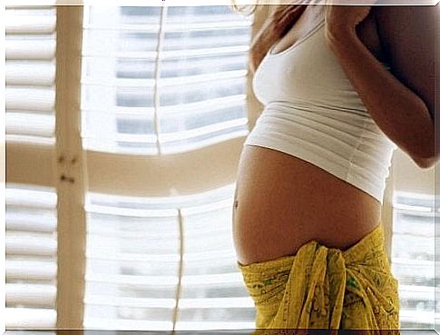 Pregnant woman with a scarf on her hip