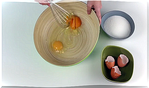 Woman whisking eggs for Swiss meringue