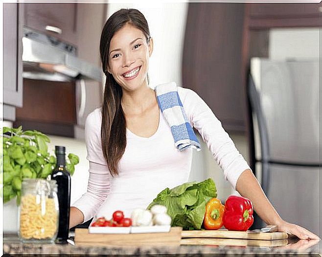 Woman in the kitchen with vegetables.